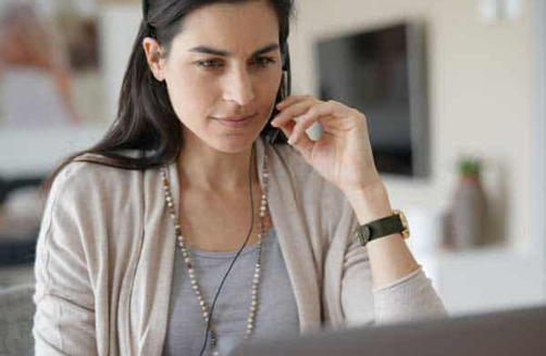 A call centre worker talks on the phone