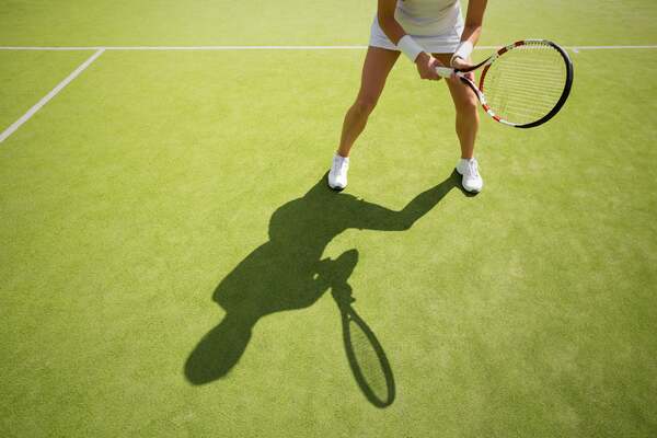 Tennis player prepares to receive a serve