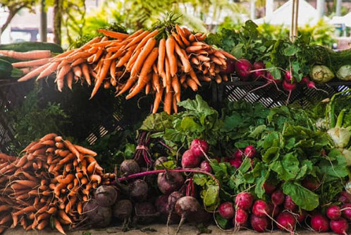 Heaped piles of vegetables including carrots and beetroot