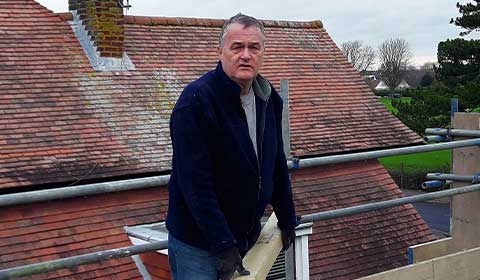 Paul Cripps working on a roof