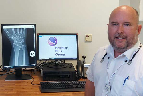 PPG Southampton's Paul Hayllar sitting next to a computer showing x-ray scan