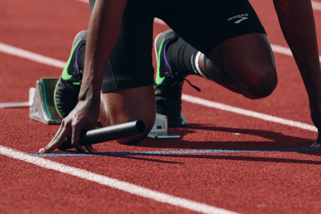 Track runner crouches before a race