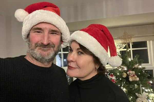 Hip patient Linda and her partner in Santa hats